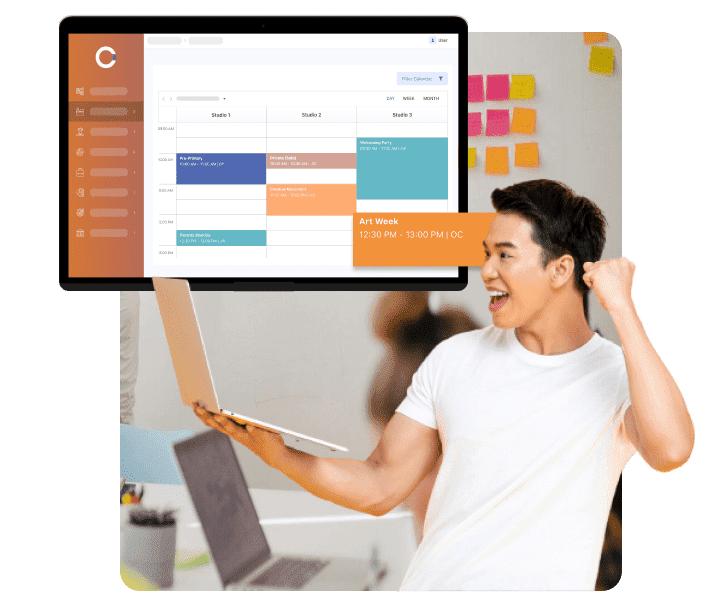 Man excited while holding laptop and OClass schedule on desktop screen